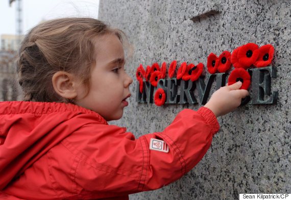 Joelle Choueiry, 3, of Ottawa, places a poppy on the National War Memorial following the Remembrance Day ceremony, in Ottawa in a November 11, 2015, file photo. THE CANADIAN PRESS/Sean Kilpatrick