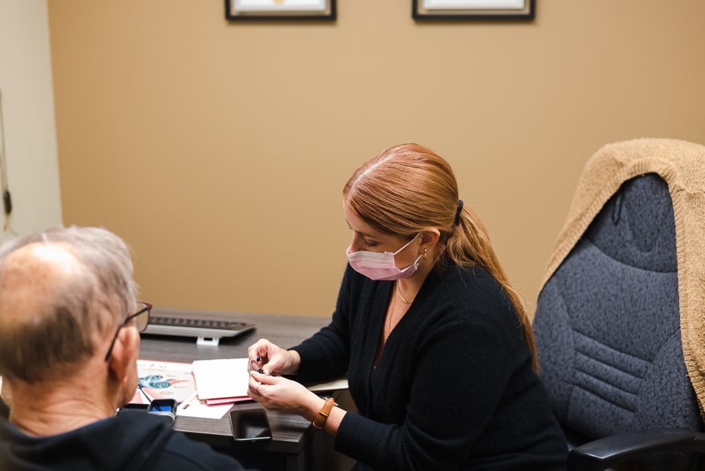 Candice Holden assisting a client at the Polo Park hearing centre